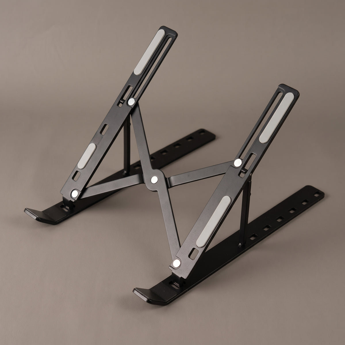 Adjustable laptop stand opened to a middle locking height