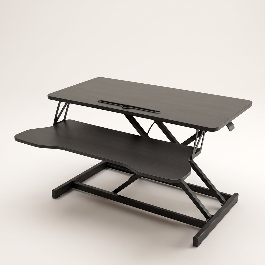 Sit-stand desk converter raised to mid height, showing the upper platform, keyboard tray and scissor lift