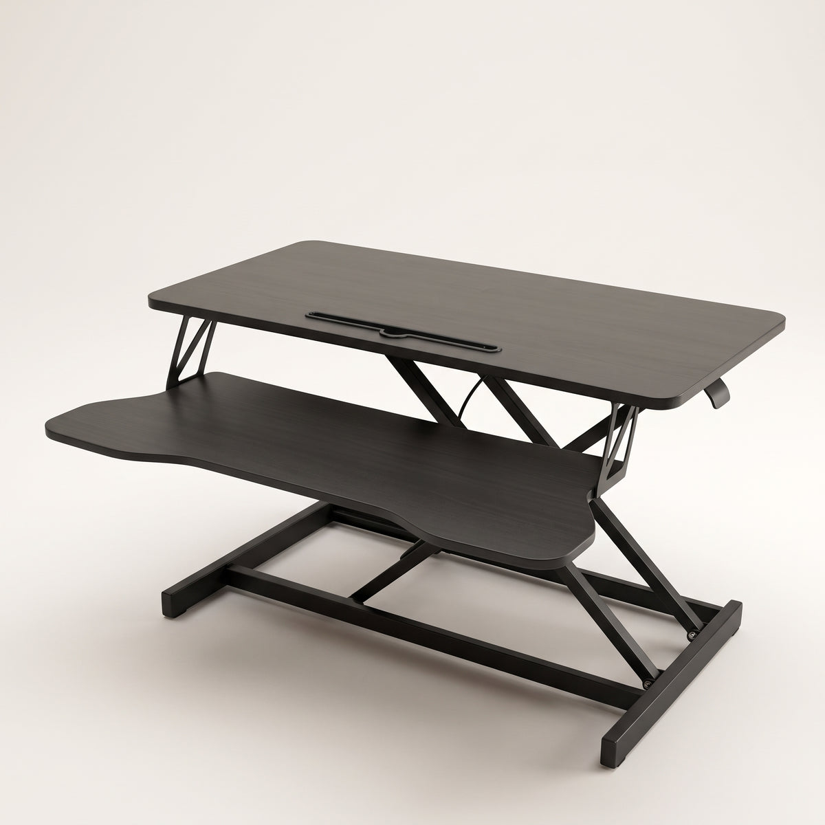 Sit-stand desk converter raised to mid height, showing the upper platform, keyboard tray and scissor lift