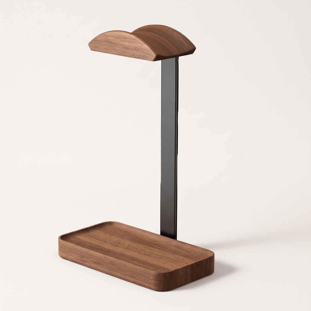 Walnut headphone stand with a curved yoke on a black post and a walnut base tray