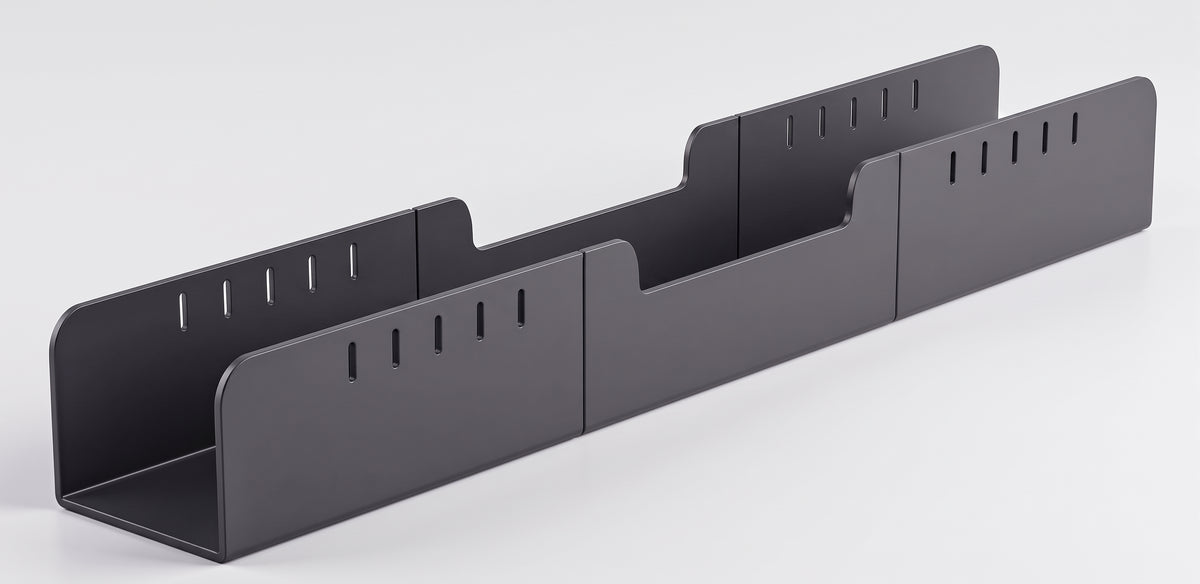 Under-desk cable tray on its own, showing the open channel and the slotted ends