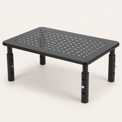 Adjustable monitor riser in black steel with a perforated top and four screw-in legs