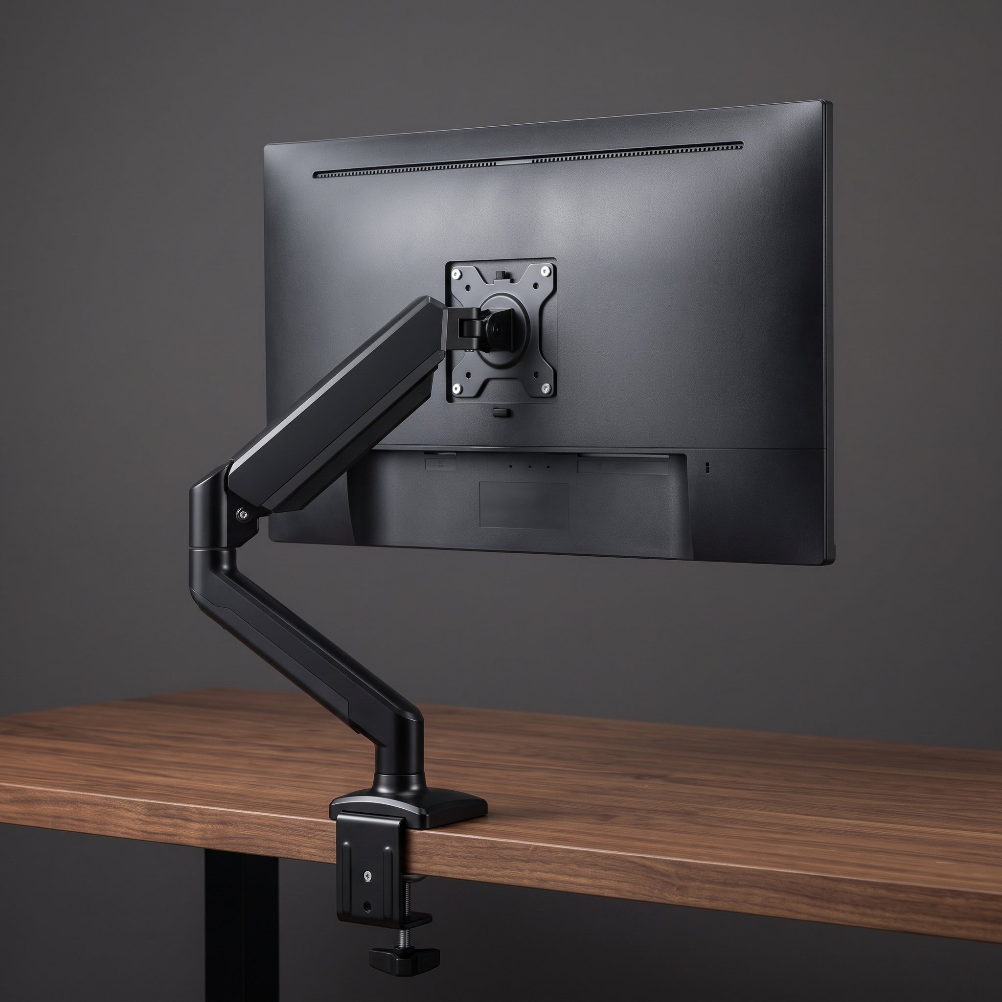 Rear view of the gas spring monitor arm's VESA plate mounted to the back of a monitor