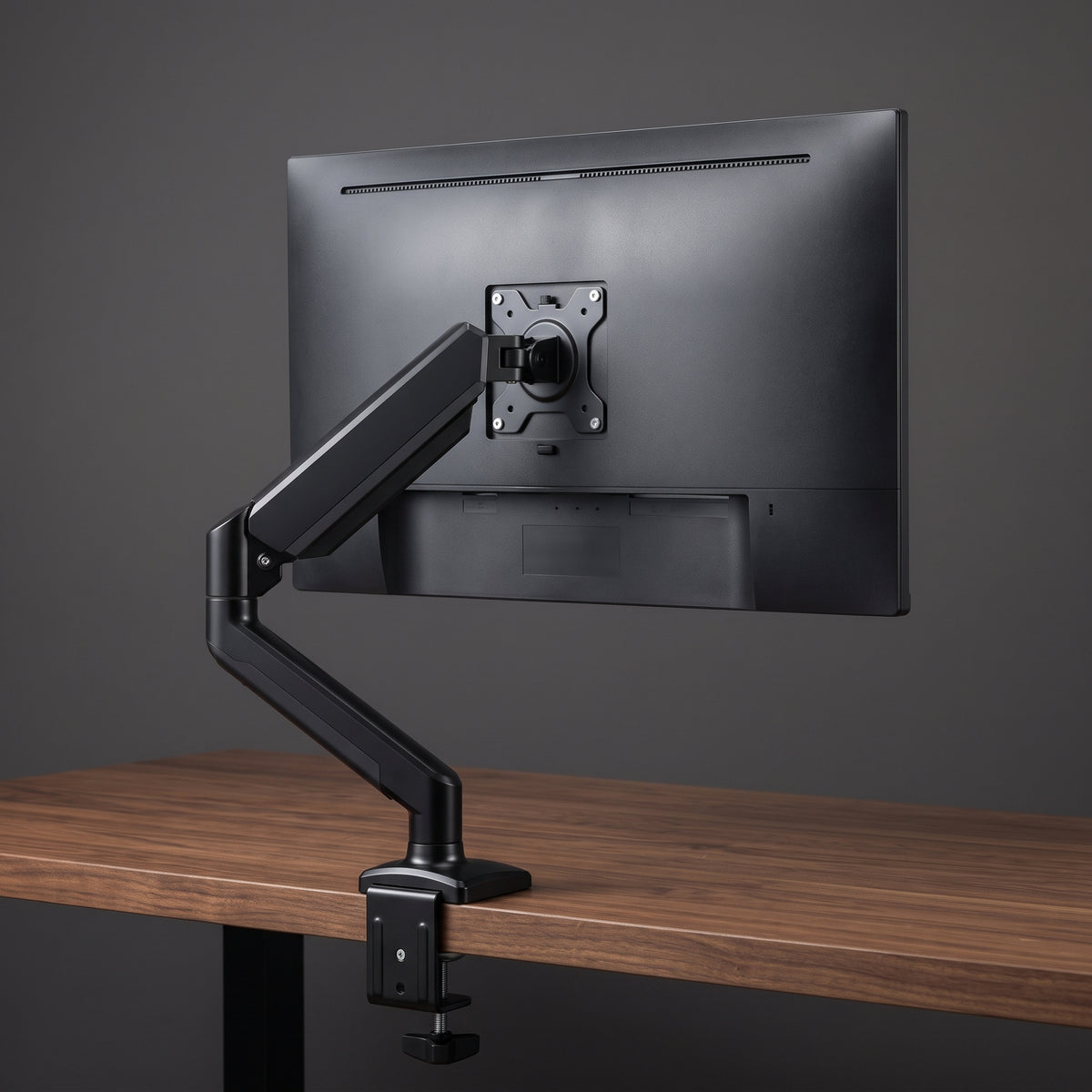Rear view of the gas spring monitor arm's VESA plate mounted to the back of a monitor