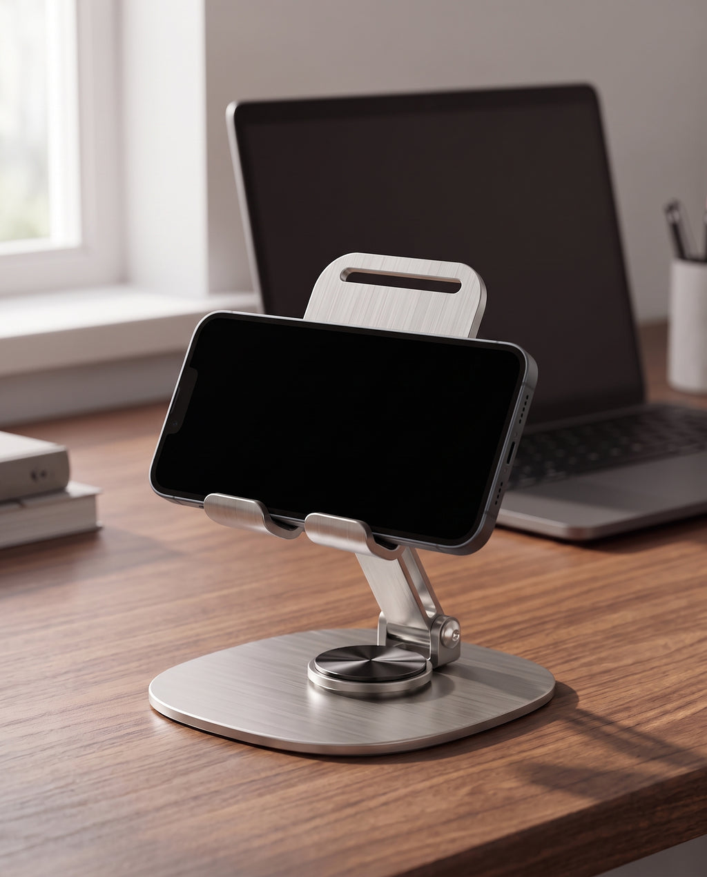 Folding phone stand holding a phone upright on a walnut desk in a home office