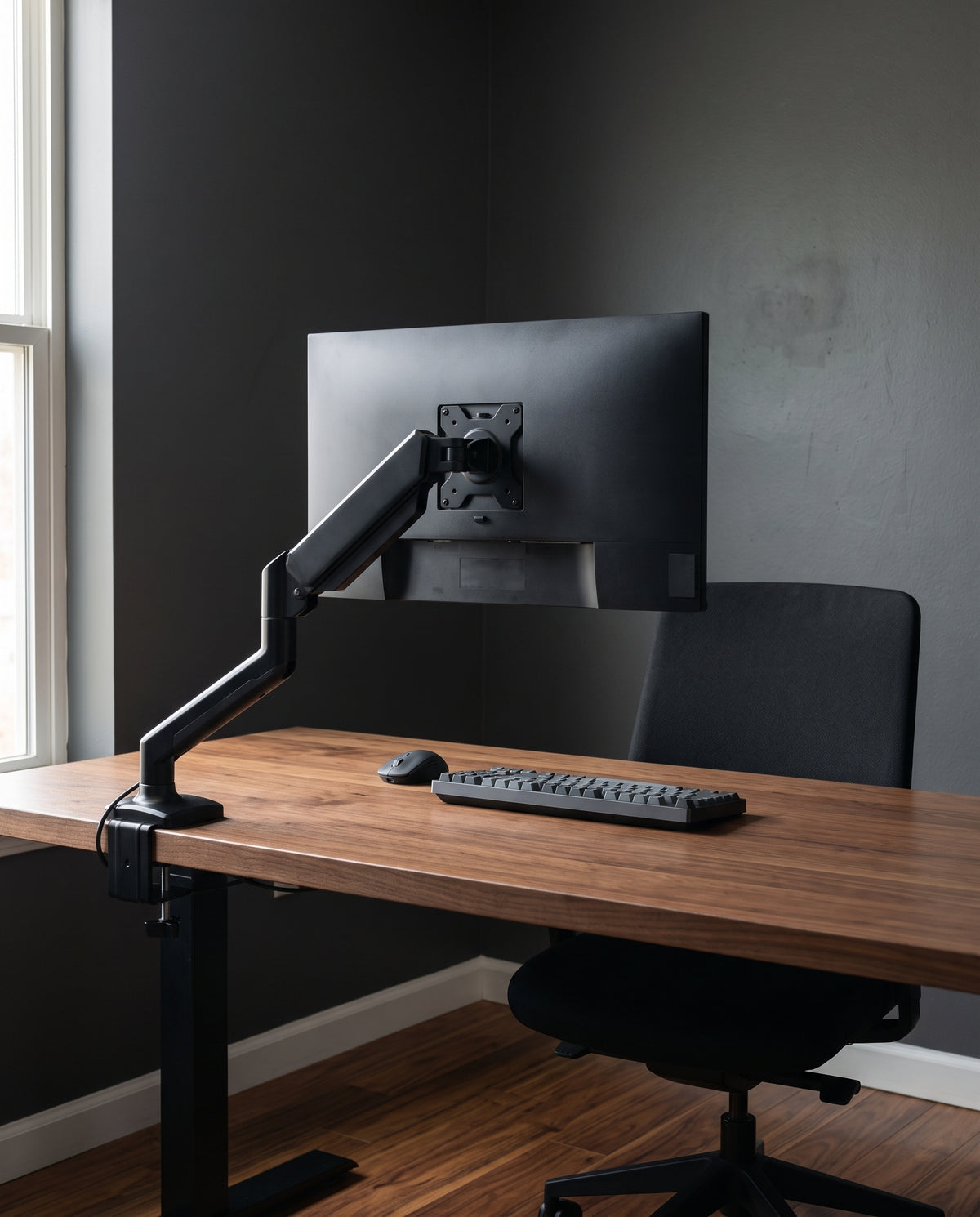 Gas spring monitor arm in use at a home office desk