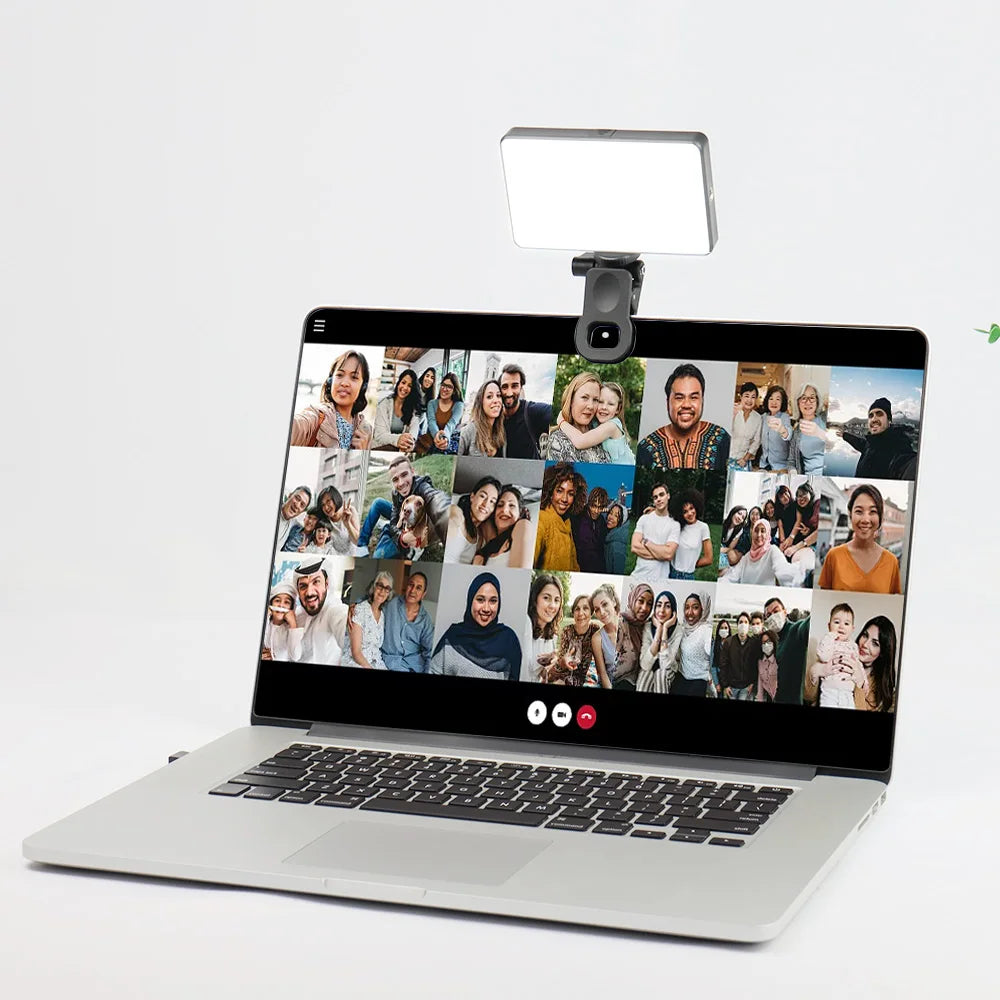 Clip-on video call light mounted on a laptop lid above the screen during a video call